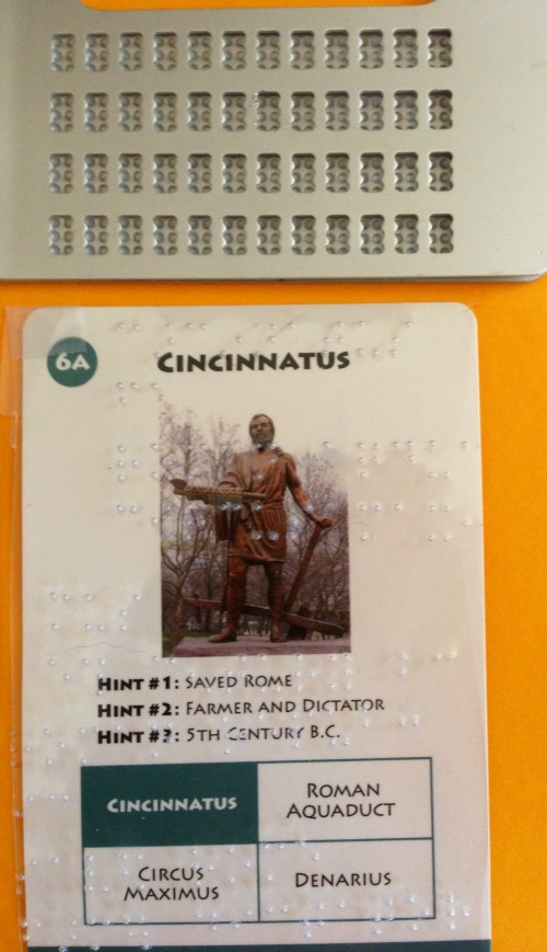 Game card of Cincinnatus overlaid with clear plastic brailled with card information.